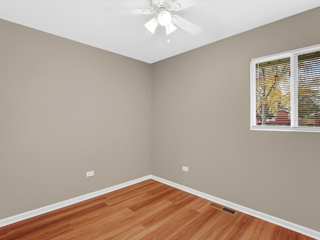 spare room featuring hardwood / wood-style flooring and ceiling fan