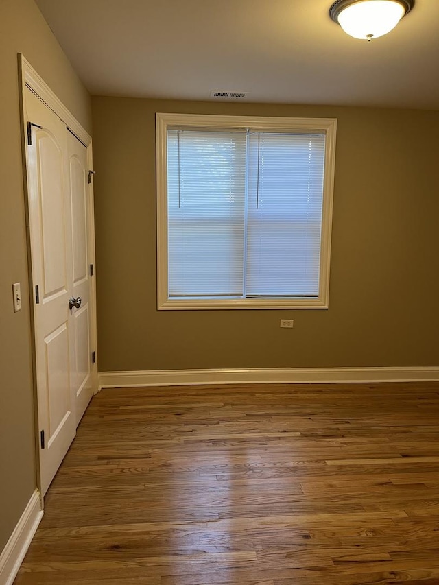 spare room with dark hardwood / wood-style flooring