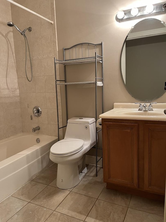 full bathroom featuring tile patterned floors, tiled shower / bath combo, toilet, and vanity