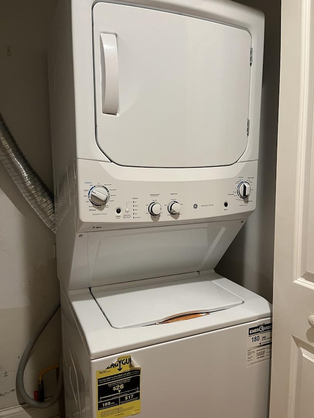 laundry area with stacked washing maching and dryer