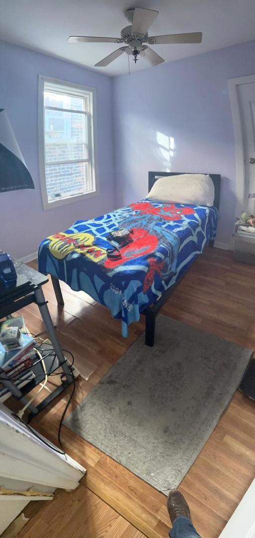 bedroom featuring hardwood / wood-style flooring and ceiling fan