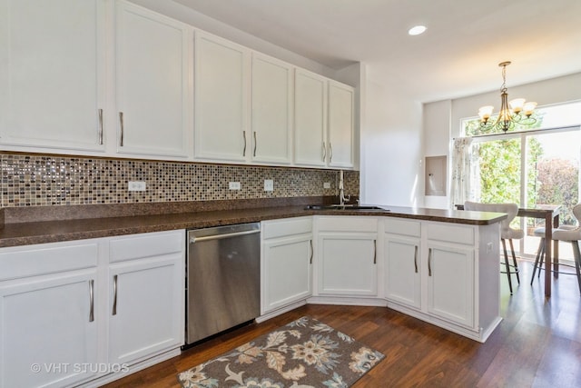 kitchen featuring dark hardwood / wood-style floors, sink, white cabinets, dishwasher, and kitchen peninsula