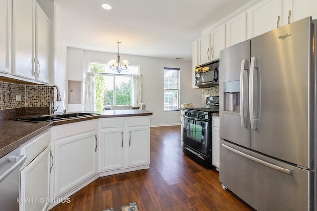 kitchen featuring dark wood-type flooring, white cabinets, sink, backsplash, and appliances with stainless steel finishes