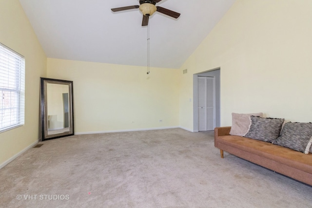 unfurnished living room featuring ceiling fan, light colored carpet, and high vaulted ceiling