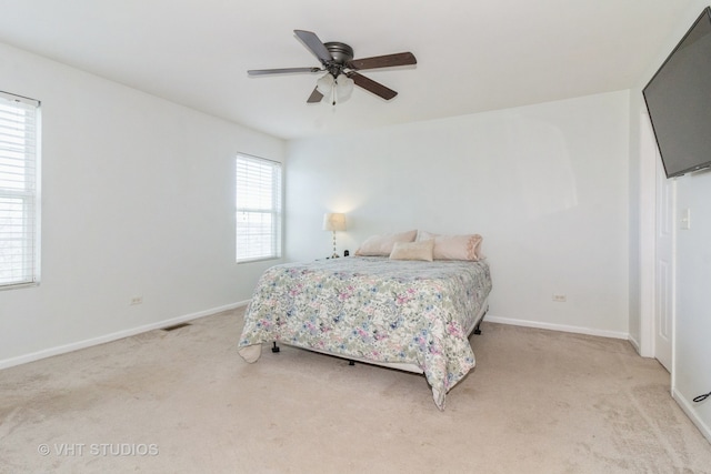 bedroom featuring ceiling fan and light carpet