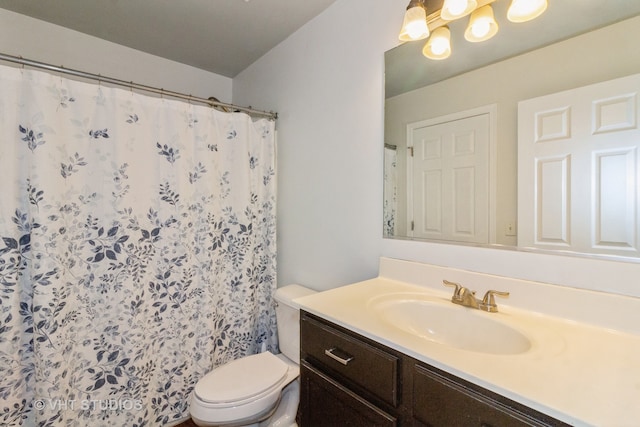 bathroom featuring a shower with curtain, vanity, and toilet