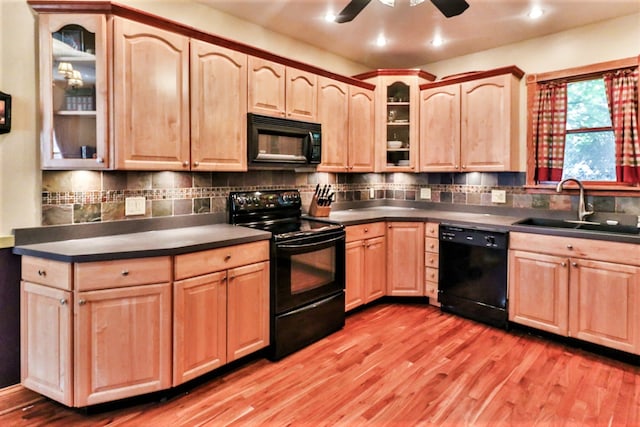 kitchen featuring backsplash, ceiling fan, sink, black appliances, and light hardwood / wood-style floors