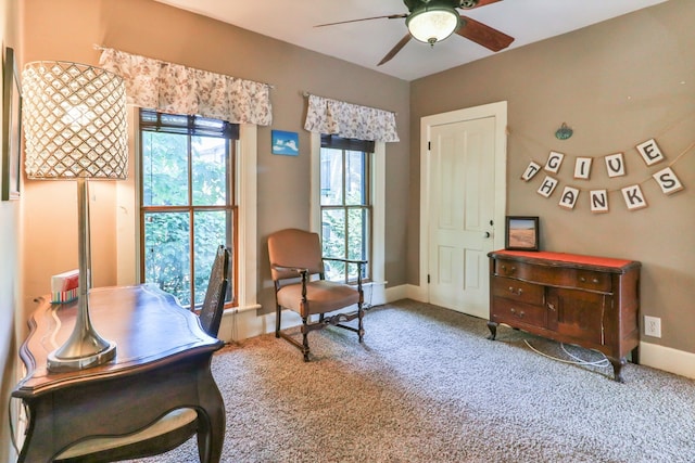 carpeted office featuring ceiling fan