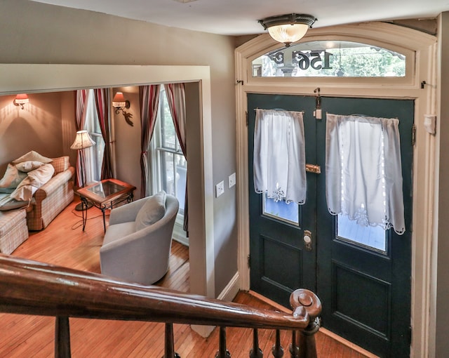 entrance foyer featuring hardwood / wood-style flooring, plenty of natural light, and french doors