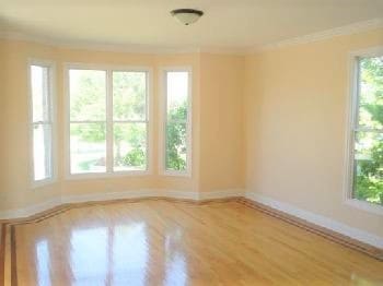 empty room with ornamental molding and a healthy amount of sunlight