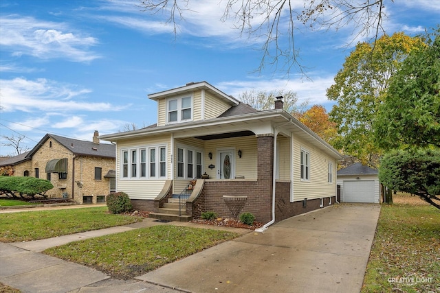 bungalow featuring a front lawn, a garage, and an outdoor structure