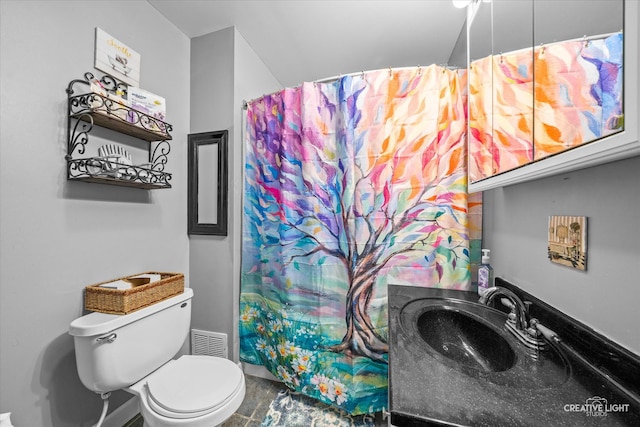 bathroom with a shower with shower curtain, toilet, and sink