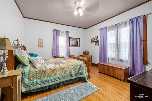 bedroom with ceiling fan, wood-type flooring, and ornamental molding