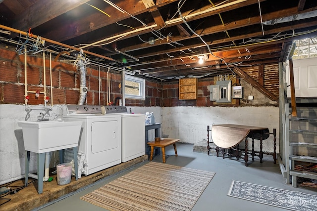 basement featuring electric panel and washer and dryer