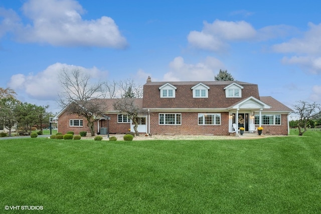 cape cod house with a front lawn and central air condition unit