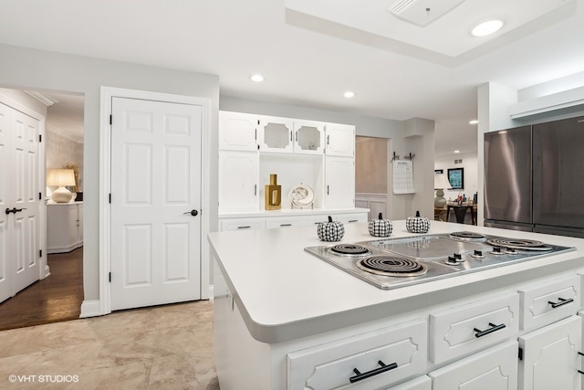 kitchen with white cabinetry, a center island, light hardwood / wood-style floors, and appliances with stainless steel finishes