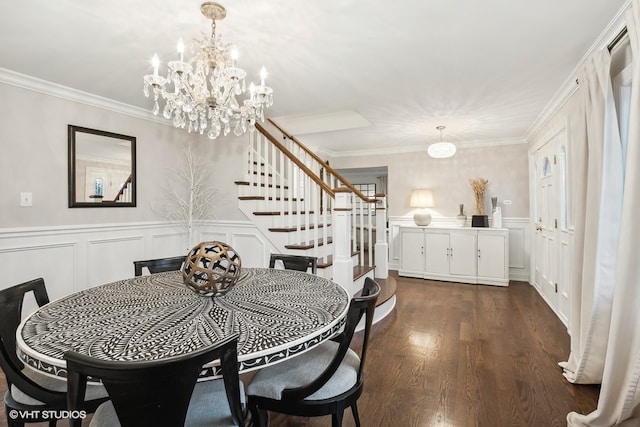 dining area featuring dark hardwood / wood-style flooring, an inviting chandelier, and crown molding