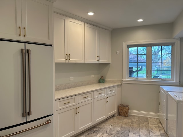 laundry area with cabinets and washing machine and dryer