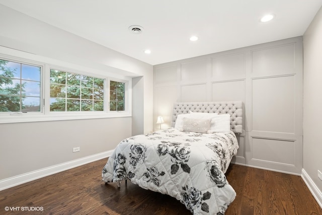 bedroom with dark hardwood / wood-style floors