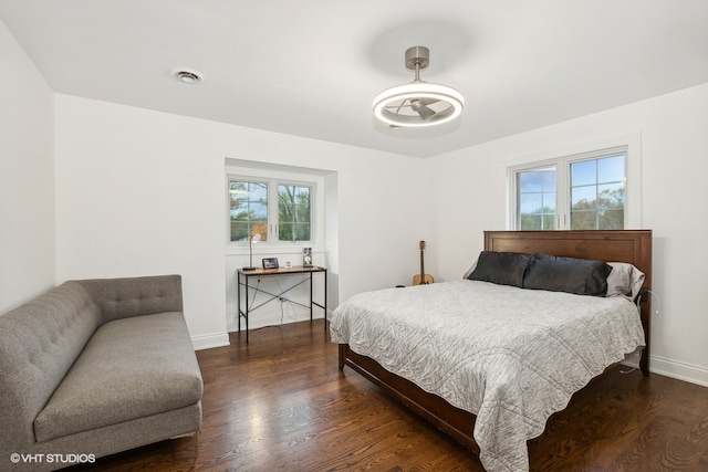 bedroom with dark hardwood / wood-style floors