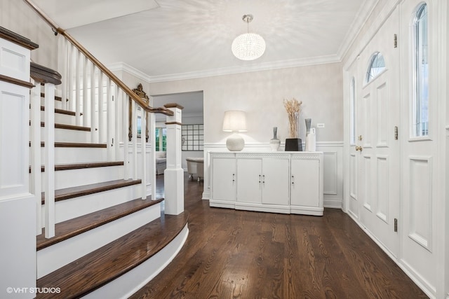 entryway with crown molding, a wealth of natural light, and dark wood-type flooring