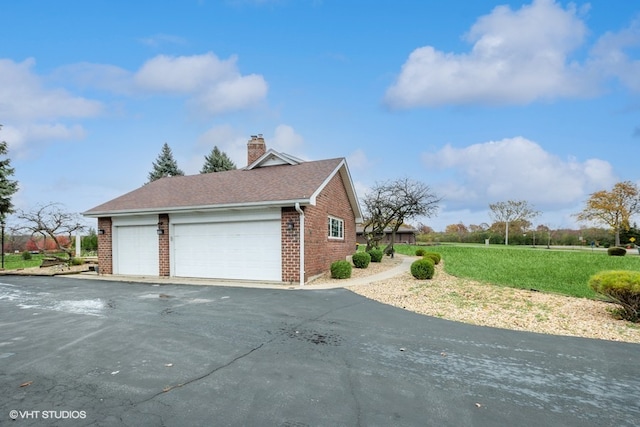 view of property exterior featuring a yard and a garage