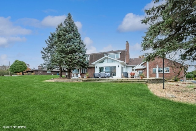 rear view of house with a yard