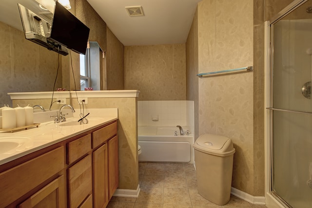 full bathroom featuring separate shower and tub, vanity, tile patterned floors, and toilet