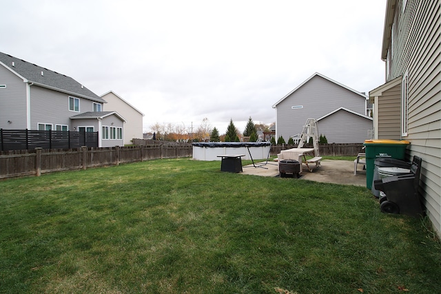 view of yard with an outdoor fire pit and a patio