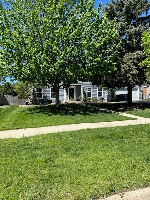 obstructed view of property with a front yard