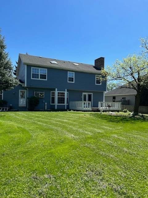 back of house featuring a yard