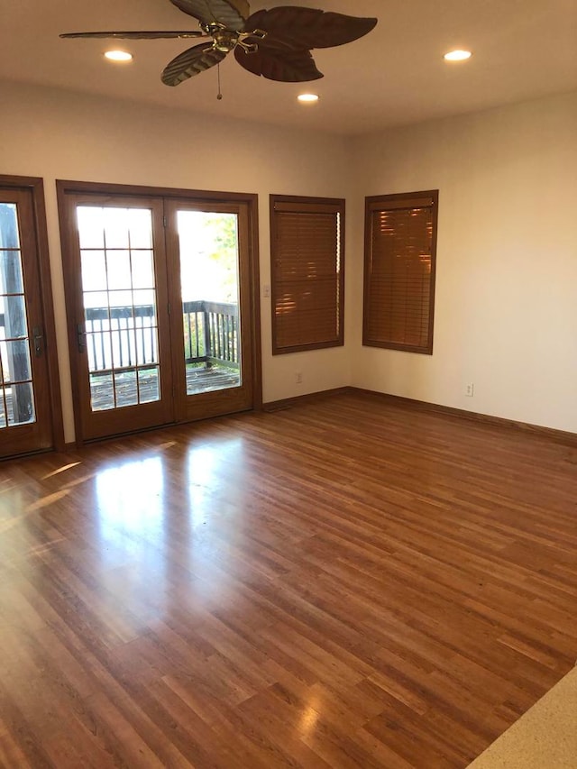 unfurnished room with dark wood-type flooring, french doors, and ceiling fan