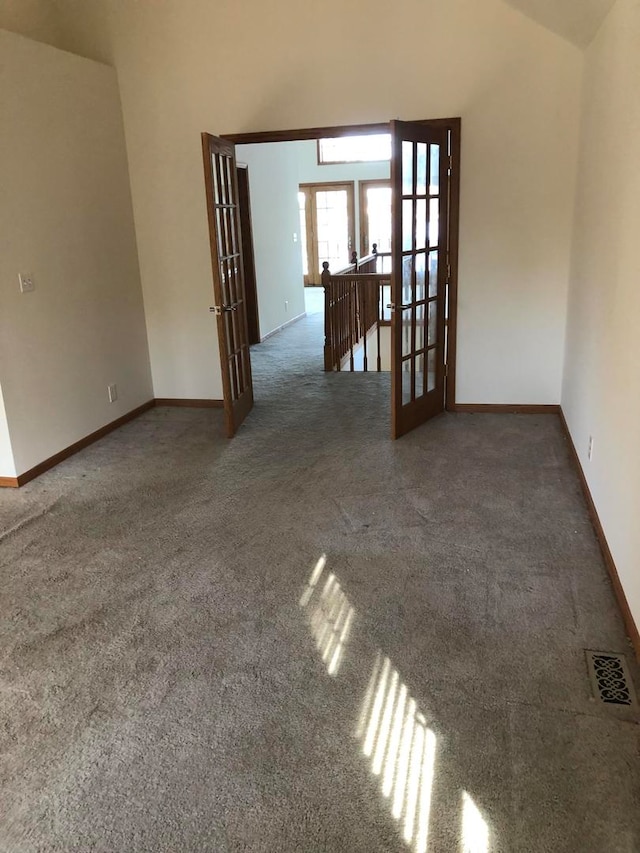 carpeted empty room featuring french doors