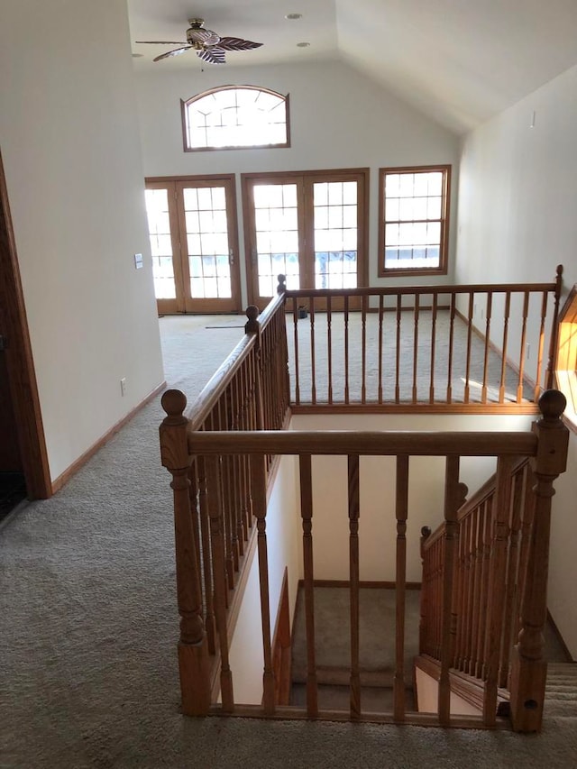 staircase featuring french doors, carpet floors, and vaulted ceiling