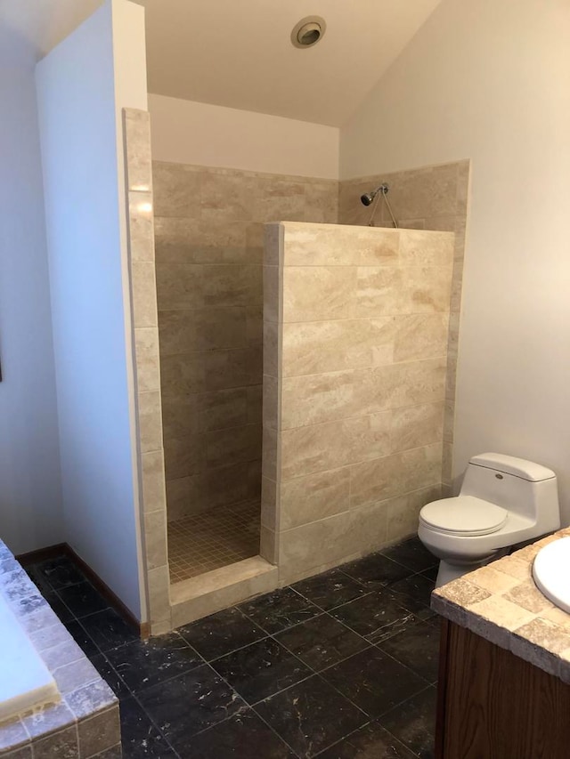 bathroom with tiled shower, vanity, tile patterned flooring, toilet, and lofted ceiling