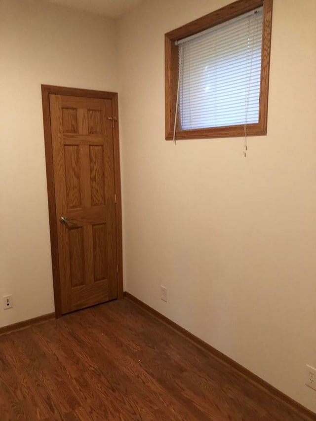 spare room with dark hardwood / wood-style flooring