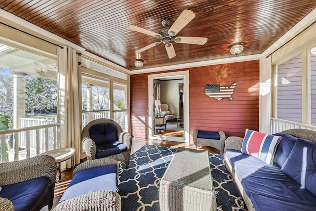 sunroom with ceiling fan and wooden ceiling