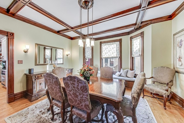 dining room featuring light wood-type flooring, crown molding, and coffered ceiling