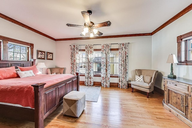 bedroom with light wood-type flooring, ceiling fan, and crown molding