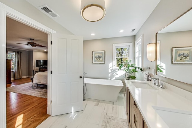 bathroom with a bathtub, ceiling fan, wood-type flooring, and vanity