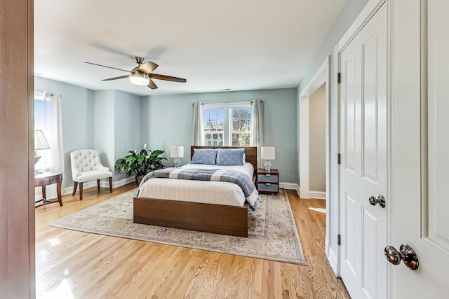 bedroom with ceiling fan and light hardwood / wood-style floors