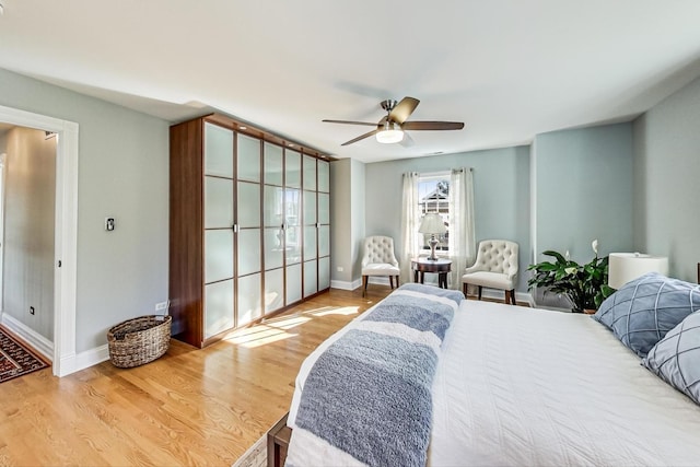 bedroom with wood-type flooring and ceiling fan