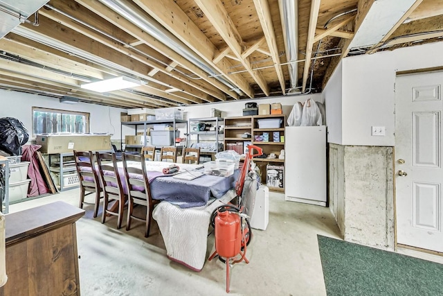 basement featuring white fridge