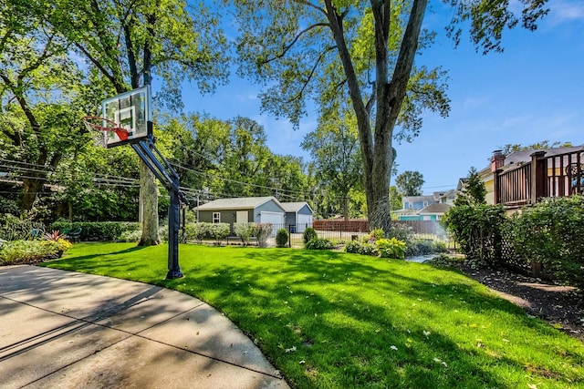 view of yard with basketball hoop