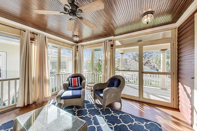 sunroom with wood ceiling, ceiling fan, and a healthy amount of sunlight