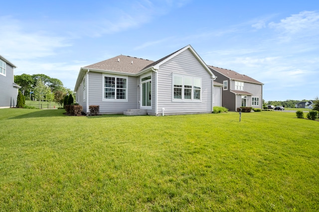 back of house featuring a yard