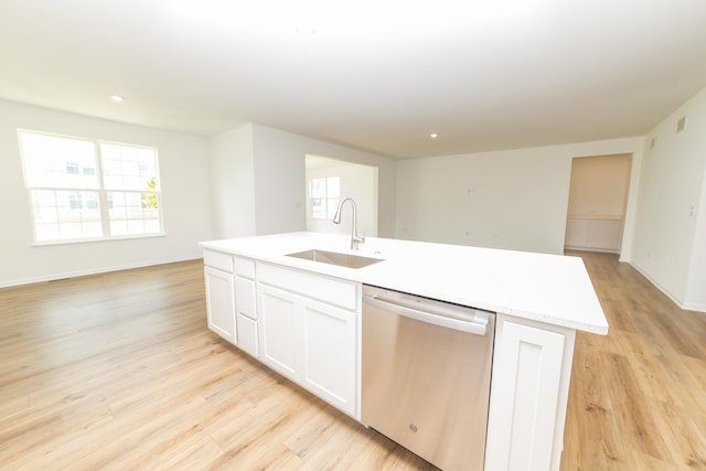 kitchen featuring stainless steel dishwasher, sink, a healthy amount of sunlight, and a kitchen island with sink