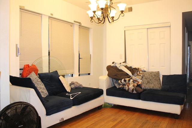 living room with hardwood / wood-style flooring and a chandelier