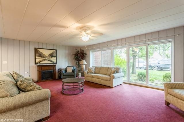 living room with carpet flooring, ceiling fan, and plenty of natural light