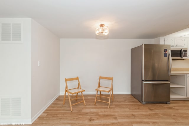 sitting room with light hardwood / wood-style flooring